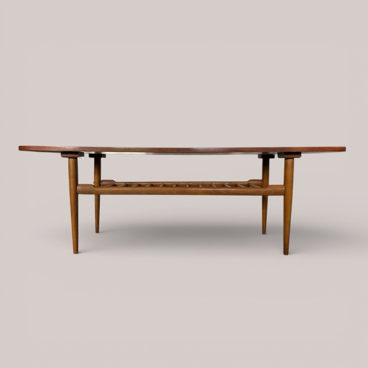 Mid-century teak coffee table with slatted magazine shelf