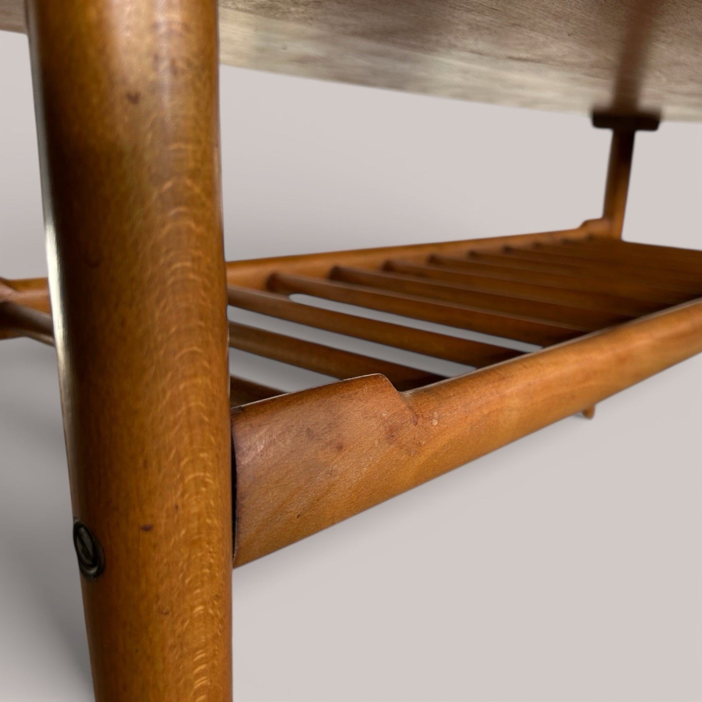 Mid-century teak coffee table with slatted magazine shelf